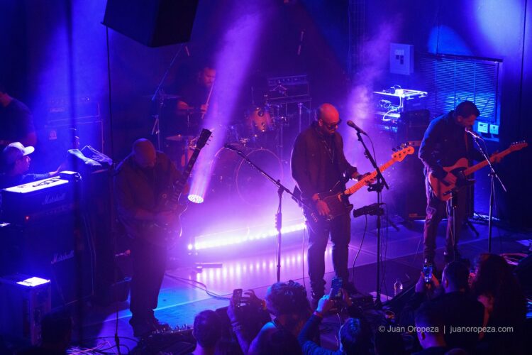 Fordelucs. La banda y la sala bajo los haces de luz violeta.